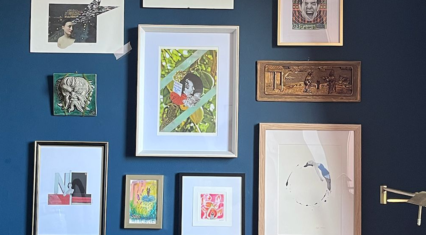 Gallery wall with diverse framed artwork at art therapy studio in Antwerp